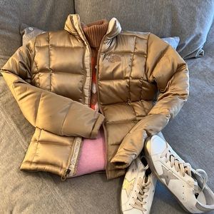 Gold metallic North Face Women’s Puffer Coat with Cream Patterned interior.